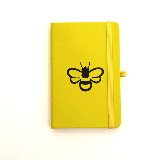 Yellow notebook with black bee outline.