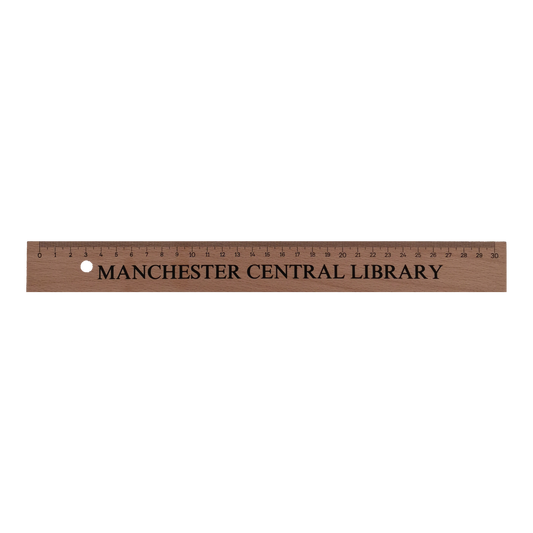 30cm wooden ruler with Manchester Central Library printed on in black text.